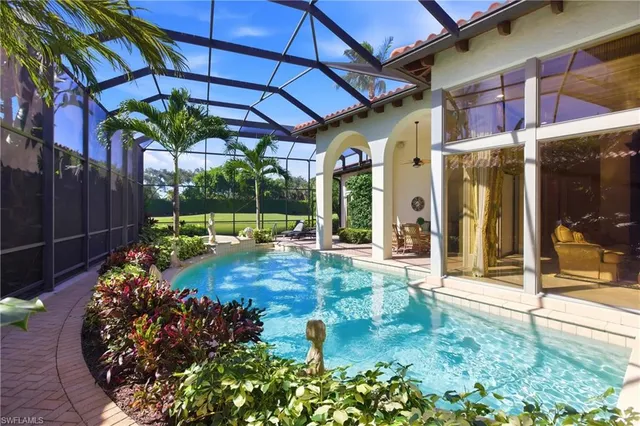 a view of brick house with potted plants and a fountain