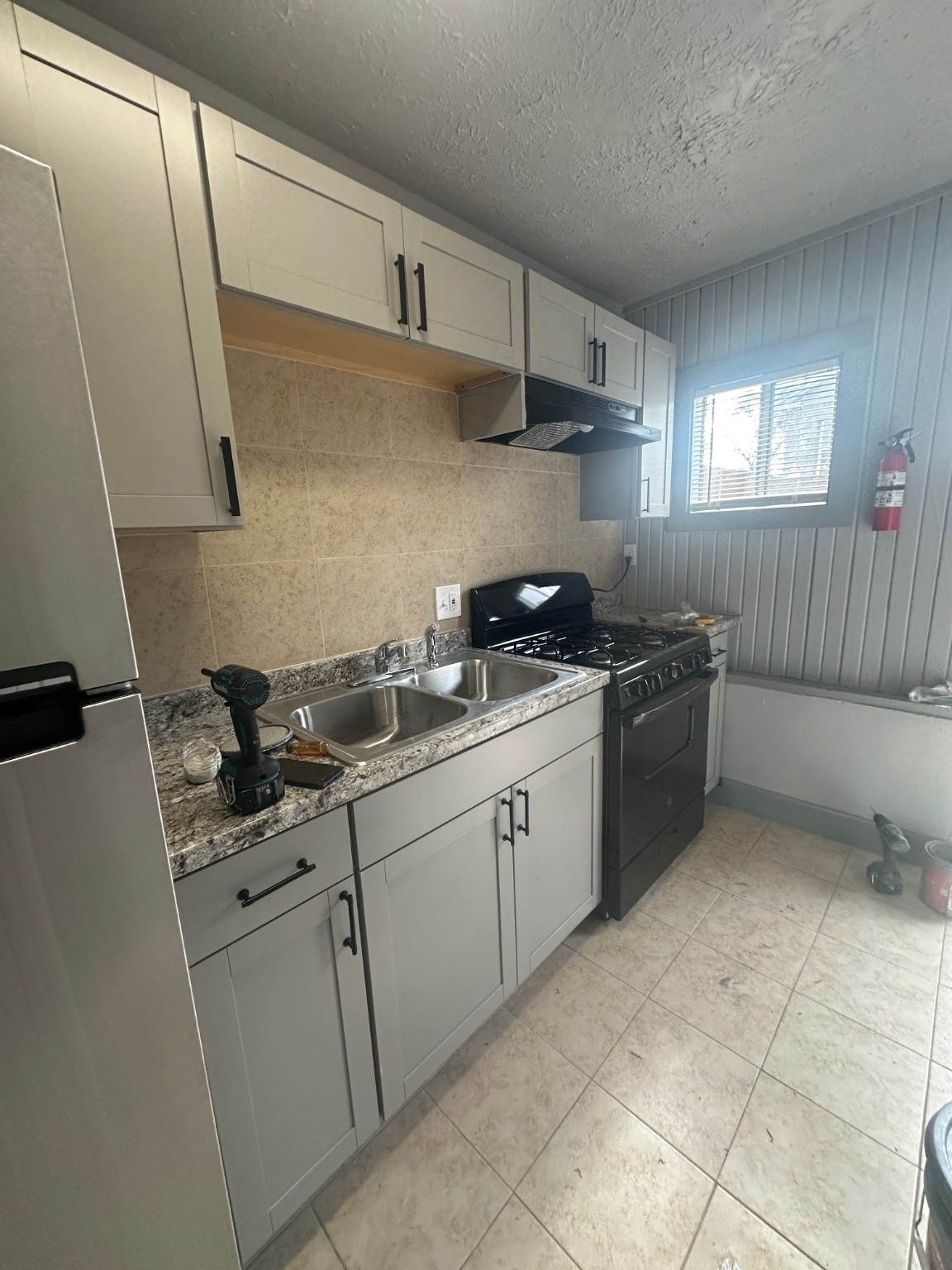 4502 Cavalcade Street Houston, TX 77026 - Photo 11 of 11 a kitchen with stainless steel appliances granite countertop a sink stove and cabinets