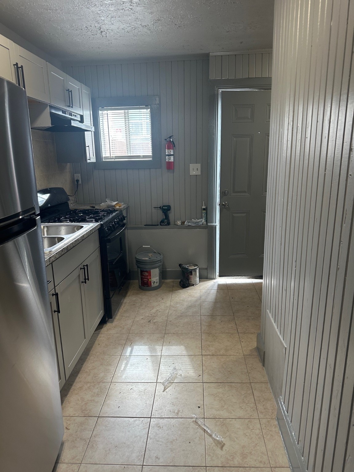 4502 Cavalcade Street Houston, TX 77026 - Photo 4 of 11 a kitchen with a cabinets and a stove top oven