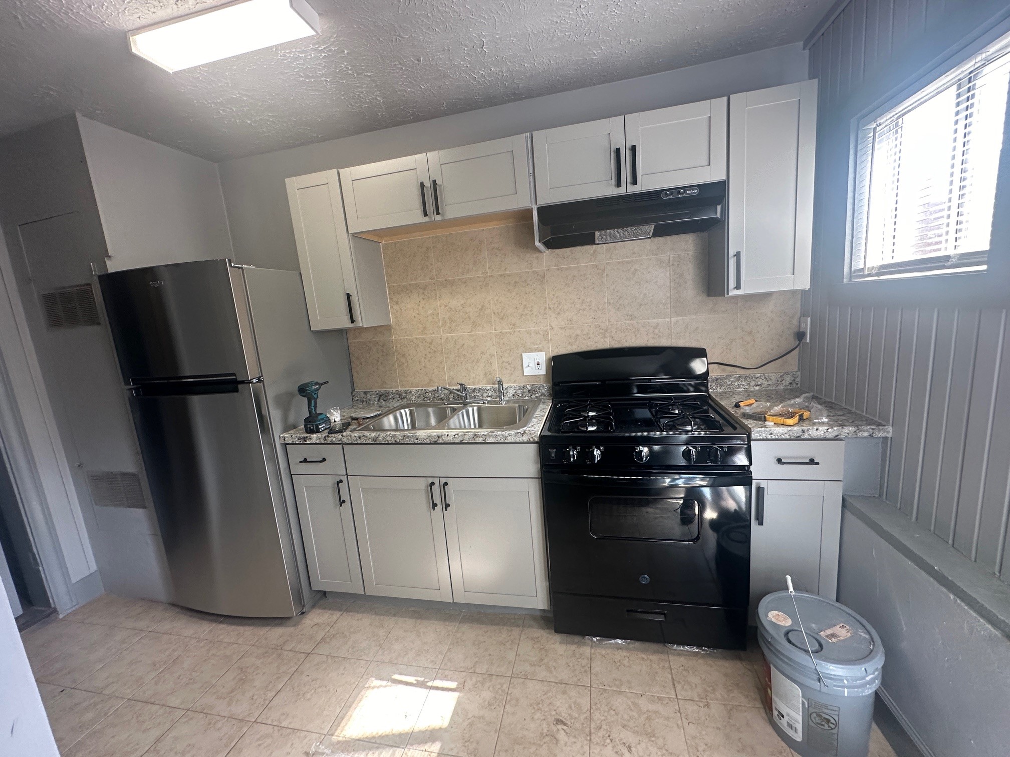4502 Cavalcade Street Houston, TX 77026 - Photo 9 of 11 a kitchen with a stove and a refrigerator