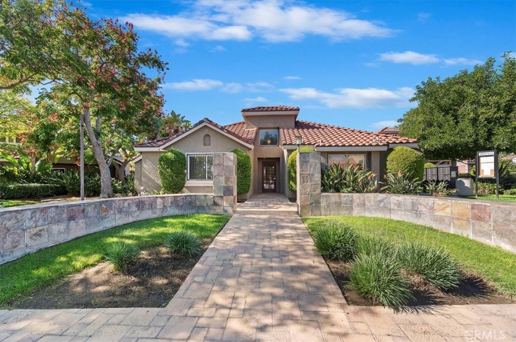 200 East Alessandro Boulevard, Unit 79 Riverside, CA 92508 - Photo 25 of 30 a front view of a house with a yard and potted plants