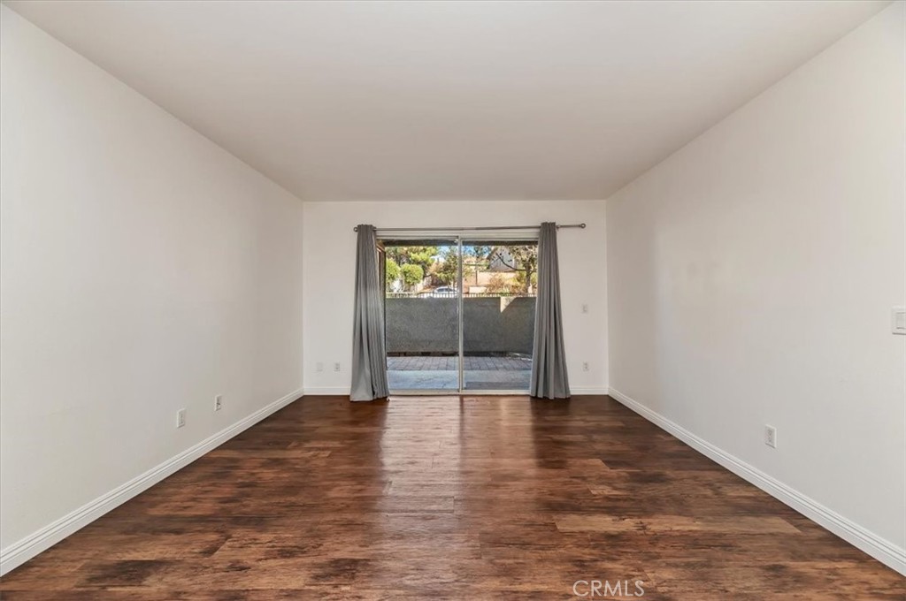 200 East Alessandro Boulevard, Unit 79 Riverside, CA 92508 - Photo 6 of 30 an empty room with wooden floor and windows