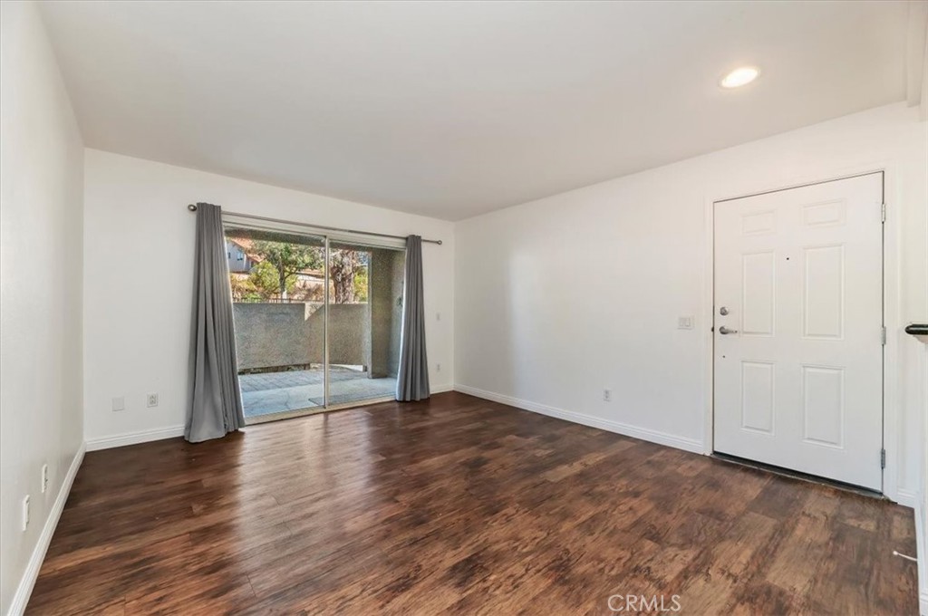 200 East Alessandro Boulevard, Unit 79 Riverside, CA 92508 - Photo 7 of 30 wooden floor in an empty room with a window