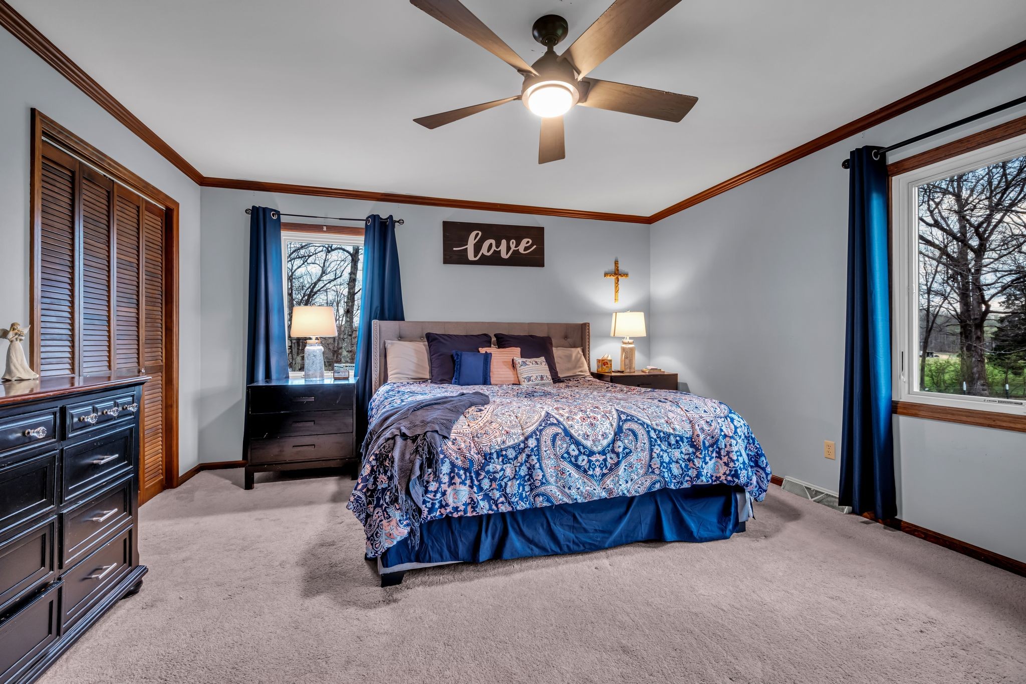 2280 C C C Road Dickson, TN 37055 - Photo 14 of 35 a bedroom with a large bed and a chandelier fan