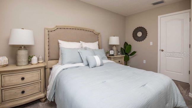 3604 Summitview Drive Lakeland, FL 33803 - Photo 13 of 23 a bedroom with a bed and a lamp on table