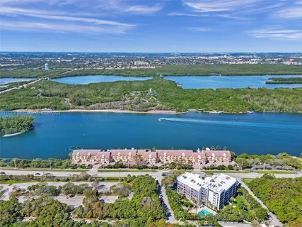 a view of a hallway with wooden floor and entryway