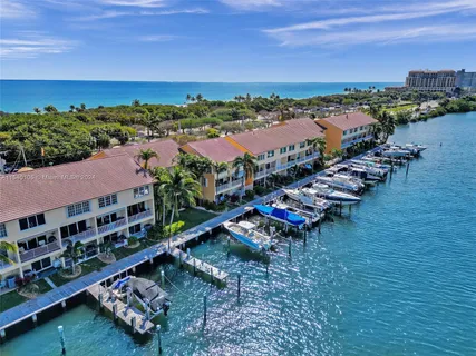a view of a dining room with furniture a chandelier and wooden floor