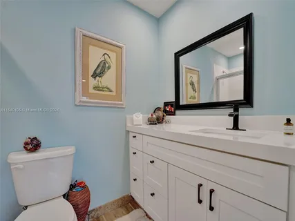 a bedroom with a bed and a refrigerator