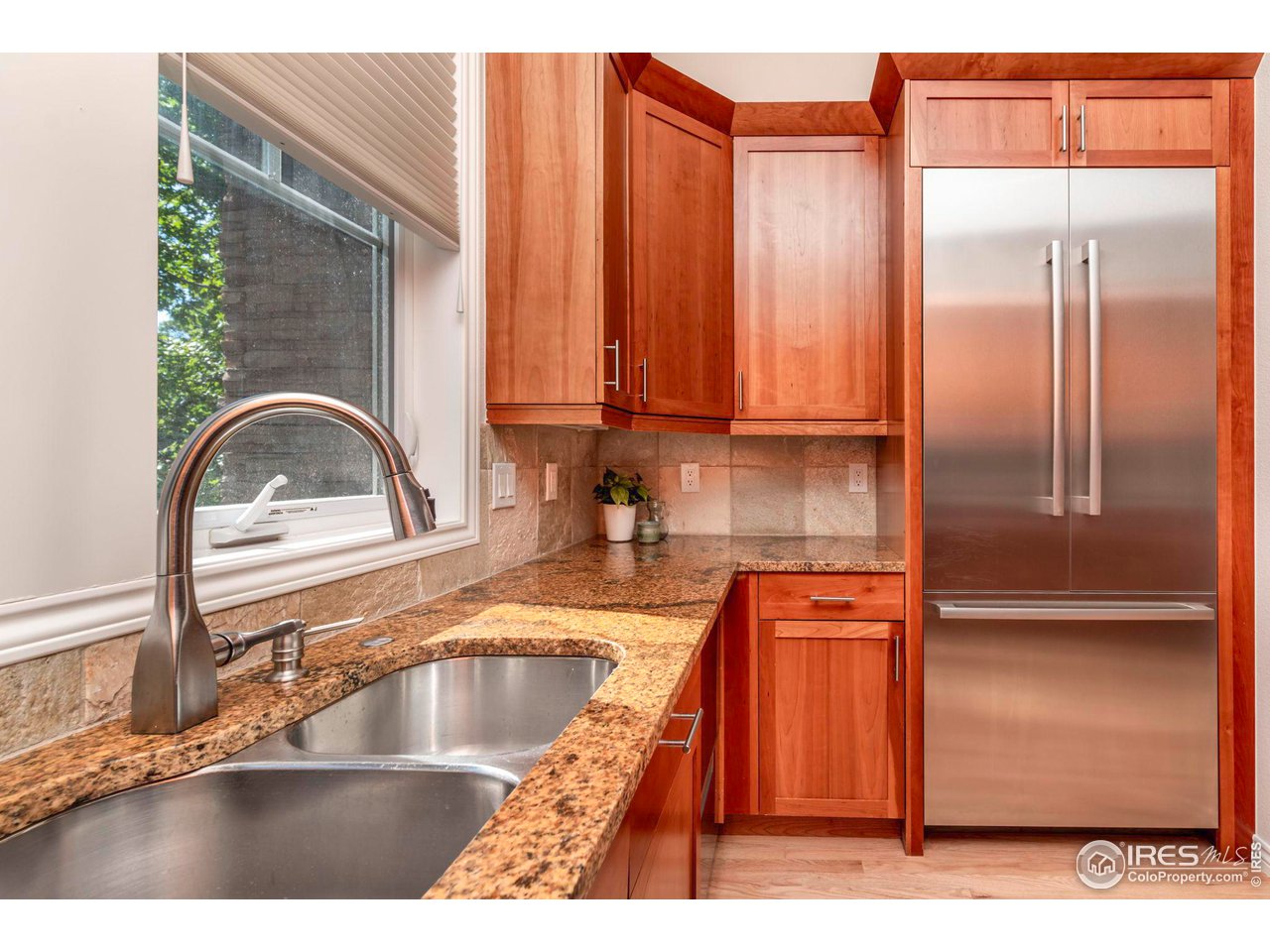 5065 3rd Street Boulder, CO 80304 - Photo 18 of 40 a kitchen with stainless steel appliances granite countertop a sink a stove and a refrigerator with wooden floor