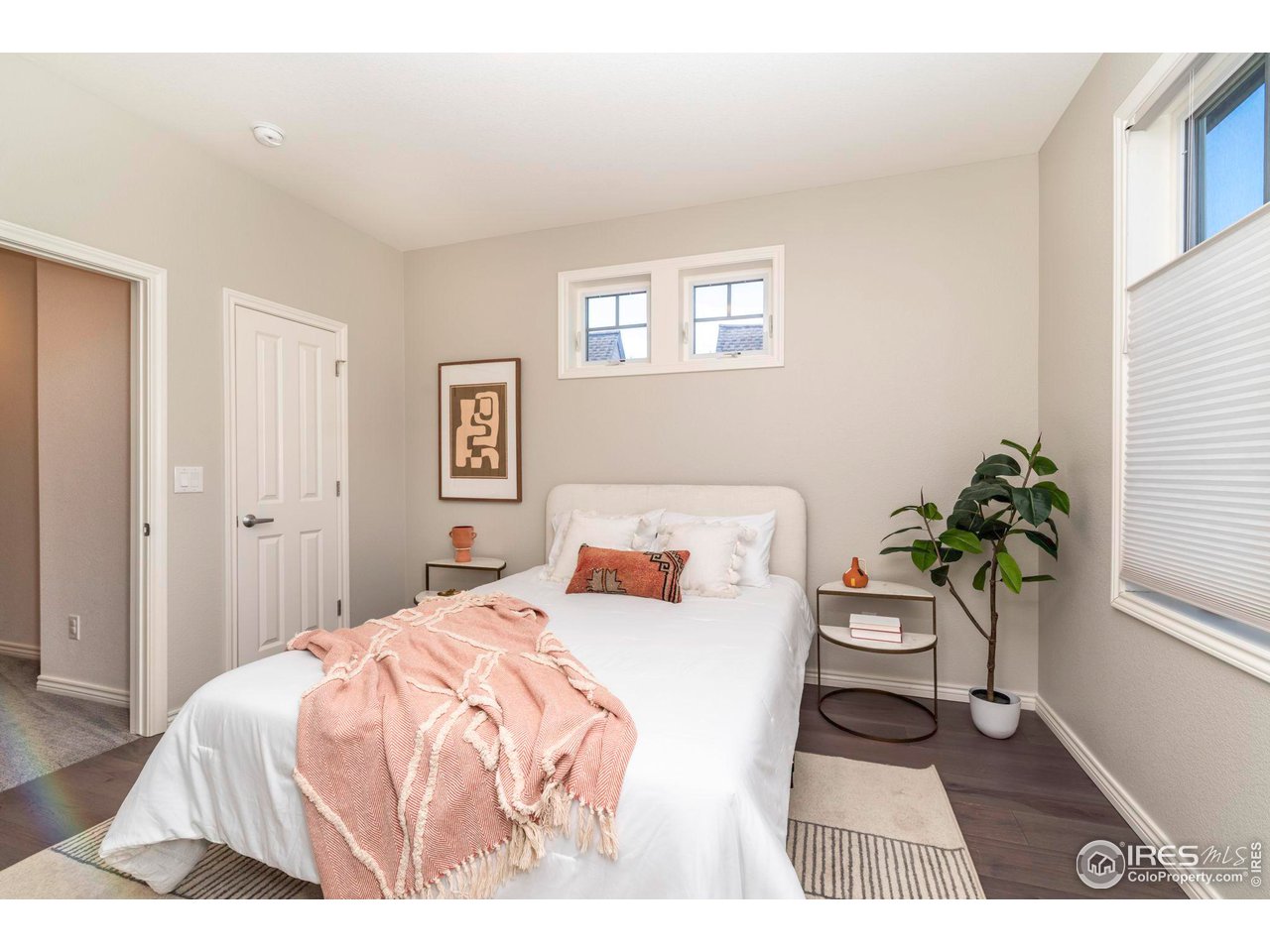 5065 3rd Street Boulder, CO 80304 - Photo 21 of 40 a bedroom with a bed a table and a potted plant