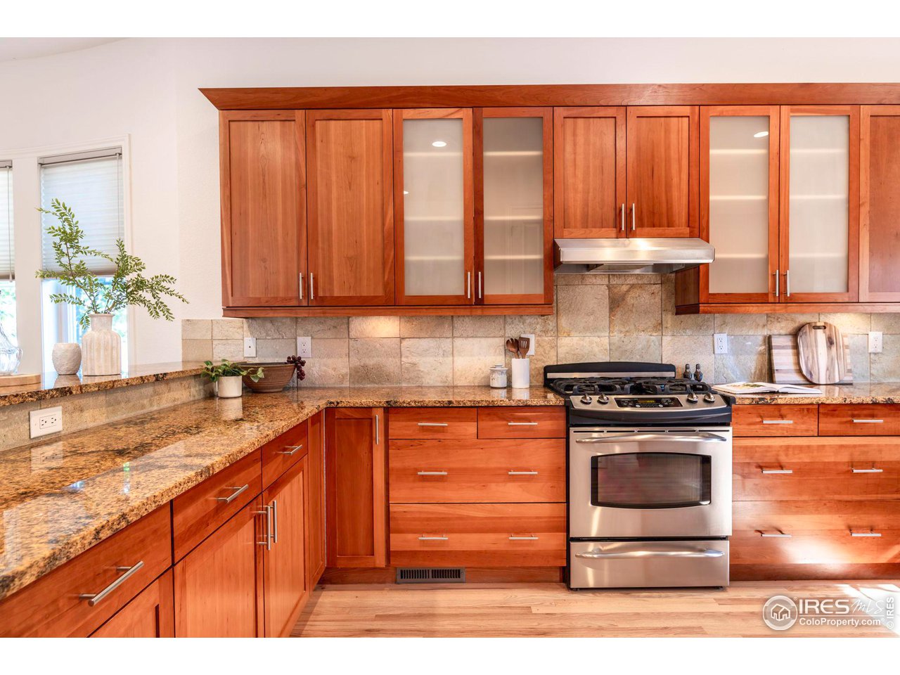 5065 3rd Street Boulder, CO 80304 - Photo 32 of 40 a kitchen with stainless steel appliances granite countertop a stove a sink and a microwave