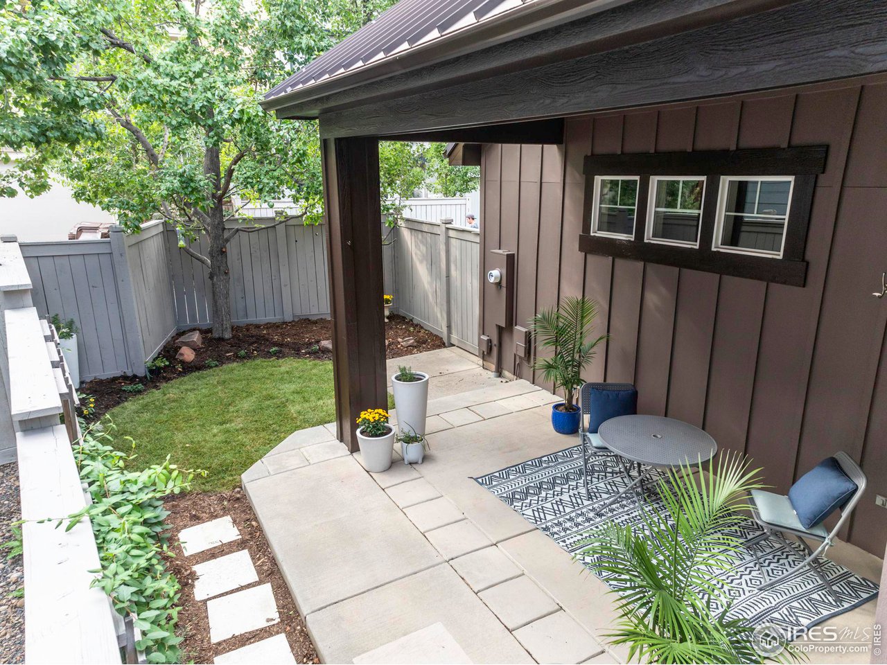 5065 3rd Street Boulder, CO 80304 - Photo 8 of 40 a view of a backyard with table and chairs potted plants and wooden fence