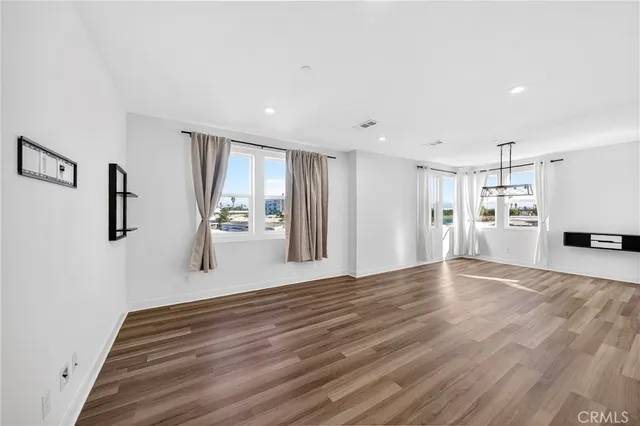a kitchen with granite countertop cabinets stainless steel appliances and a wooden floor