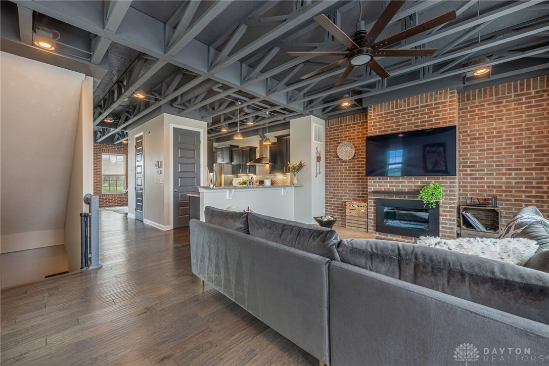 407 Brownstone Row Springboro, OH 45066 - Photo 10 of 54 This open concept living area showcases exposed brick and wood flooring.