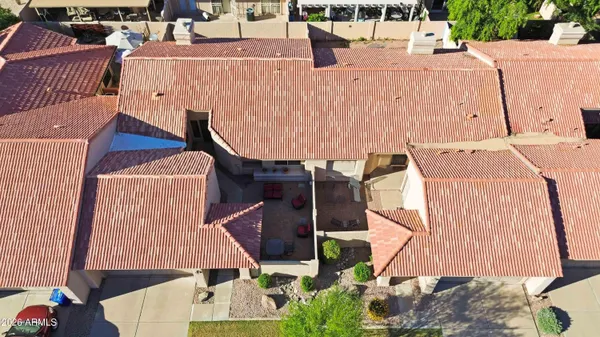 an aerial view of a house with a yard and balcony