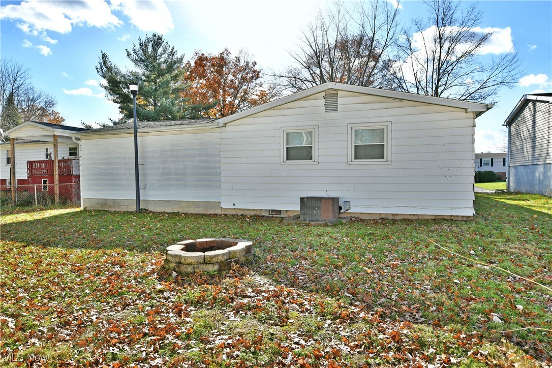 37 Morningside Road Niles, OH 44446 - Photo 9 of 39 Rear view of property featuring a fire pit and a lawn