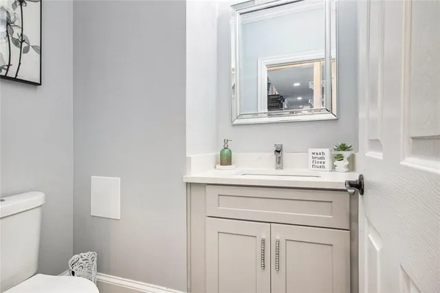 a view of a hallway with wooden floor and entryway