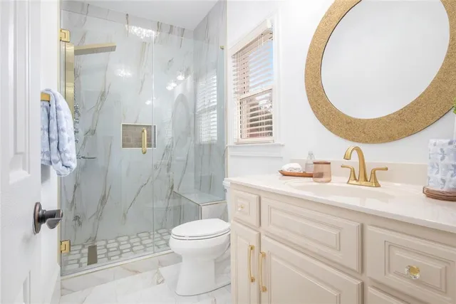 a spacious bedroom with a balcony a bed and a chandelier