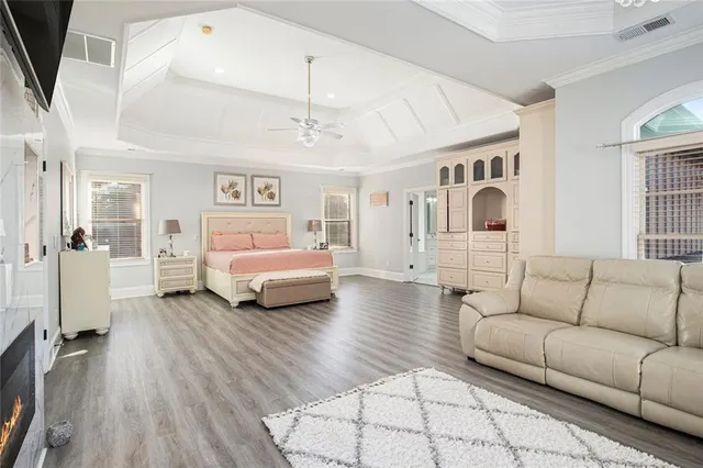 a spacious bathroom with a double vanity sink a mirror a bathtub and window