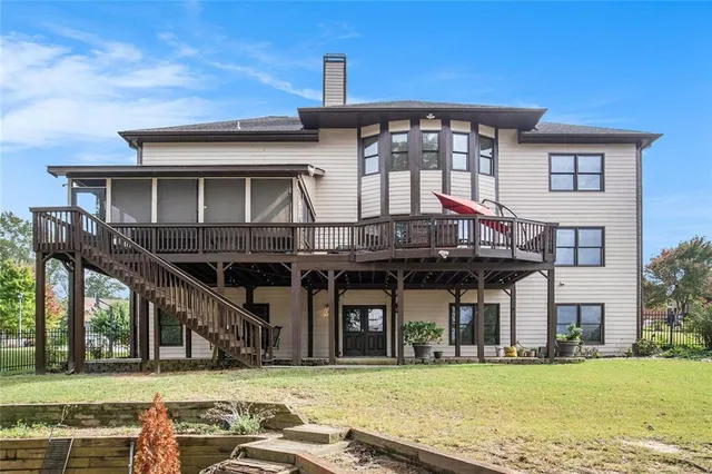 a front view of a house with a yard and potted plants