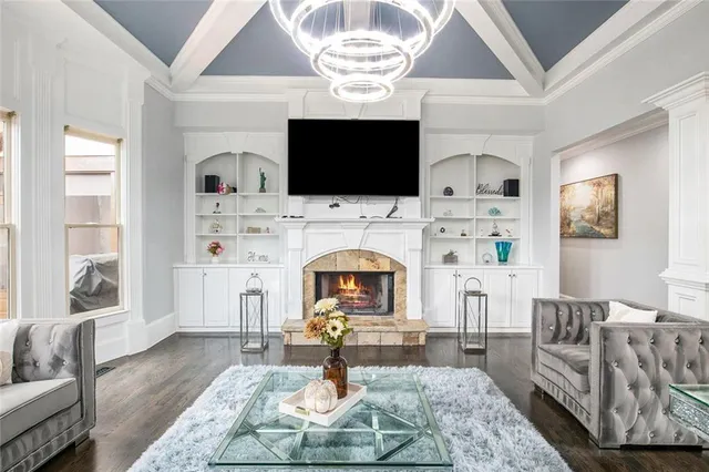 a living room with furniture and a chandelier