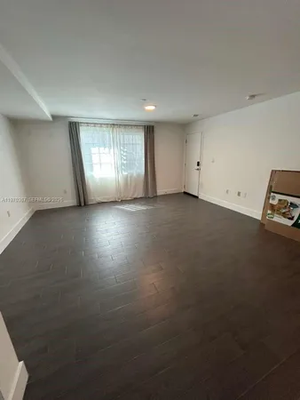 an empty room with a empty space and windows