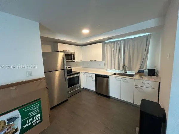 a kitchen with a refrigerator sink and microwave