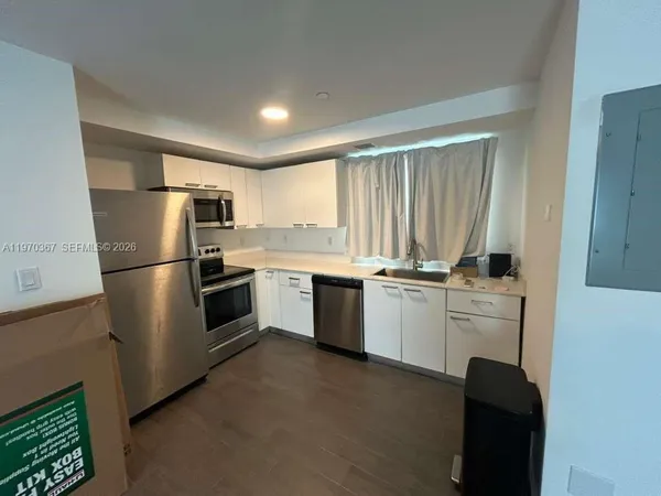 a kitchen with a refrigerator stove and sink