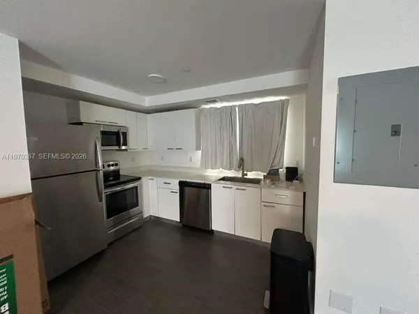 a kitchen with a refrigerator stove and sink