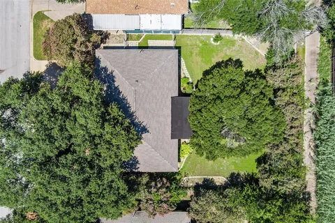 an aerial view of a house with a yard and garden