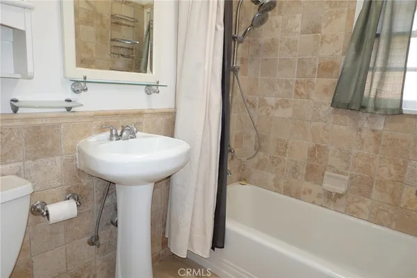 a bathroom with a sink toilet and bathtub