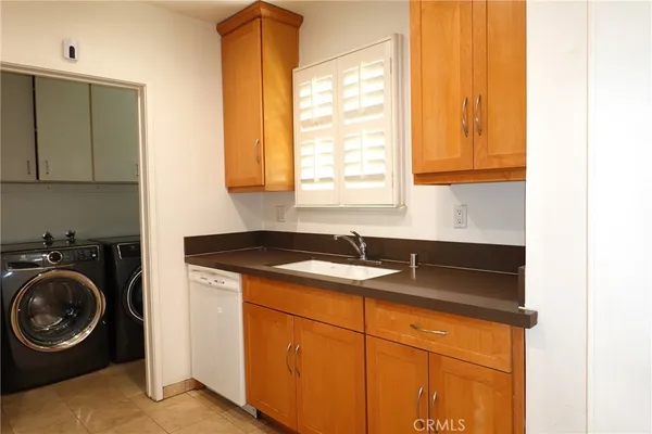 a kitchen with a sink cabinets and a window