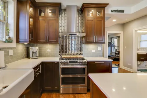 a kitchen with stainless steel appliances a stove a sink and a refrigerator