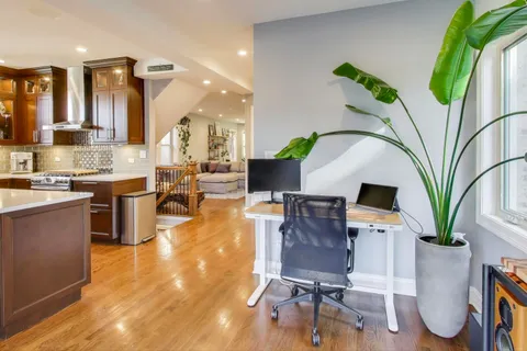 a living room with furniture a wooden floor and a sink
