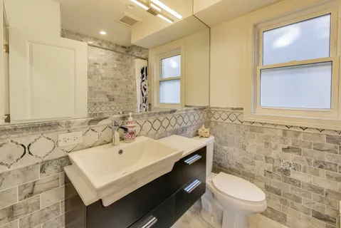 a bathroom with a sink toilet and shower