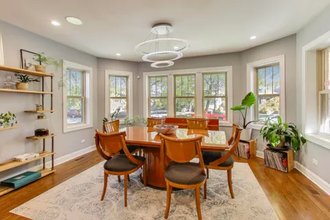 a dining room with furniture and wooden floor