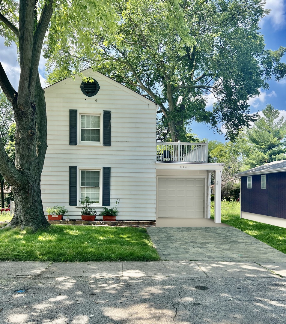 564 Mann Place Elgin, IL 60120 - Photo 1 of 28 a front view of a house with garden