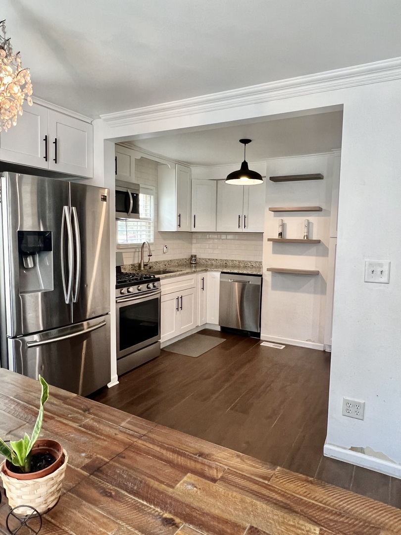 564 Mann Place Elgin, IL 60120 - Photo 11 of 28 a kitchen with stainless steel appliances a stove refrigerator and cabinets
