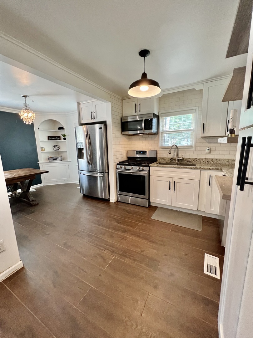 564 Mann Place Elgin, IL 60120 - Photo 12 of 28 a kitchen with stainless steel appliances a stove refrigerator and a sink