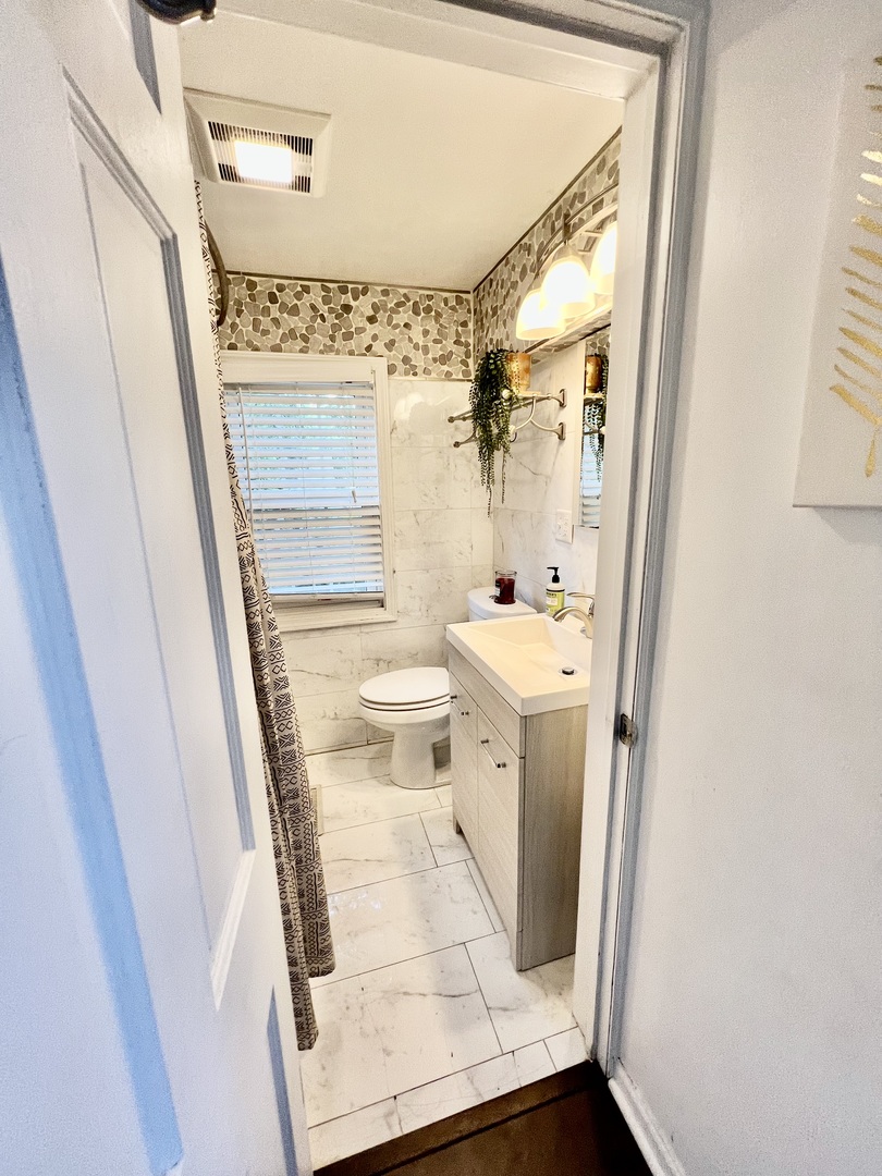 564 Mann Place Elgin, IL 60120 - Photo 15 of 28 a bathroom with a sink a toilet and a mirror