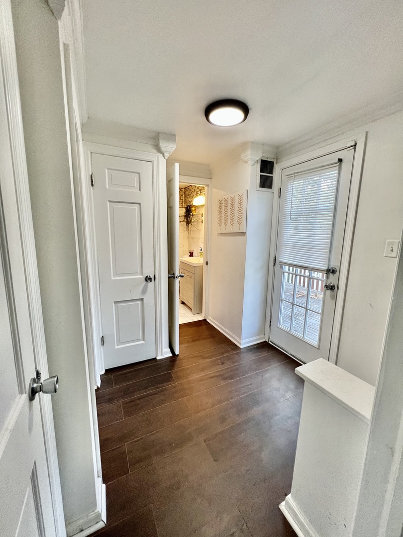 564 Mann Place Elgin, IL 60120 - Photo 17 of 28 wooden floor in an empty room with a window and a kitchen