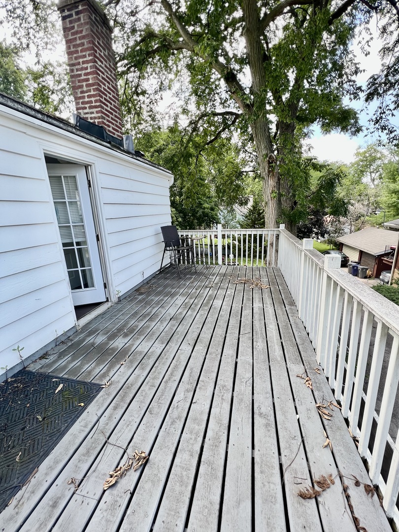 564 Mann Place Elgin, IL 60120 - Photo 20 of 28 a view of balcony with wooden floor and fence