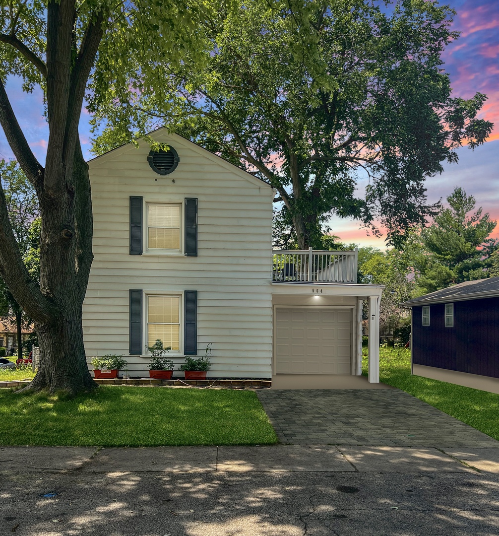 564 Mann Place Elgin, IL 60120 - Photo 2 of 28 a front view of a house with garden