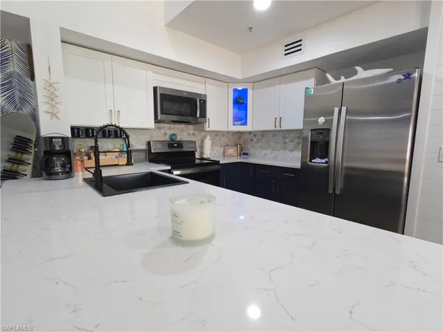 a kitchen with a sink appliances and cabinets