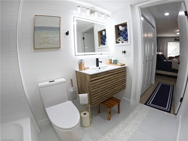 a bathroom with a sink toilet a shower and a mirror