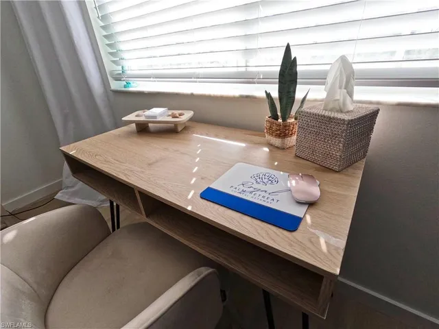 a spacious bedroom with a bed a table and chair