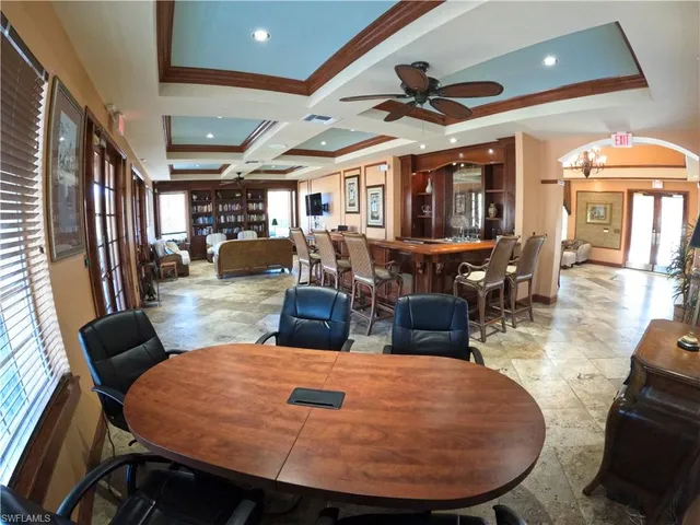 a room with pool table windows and wooden floor