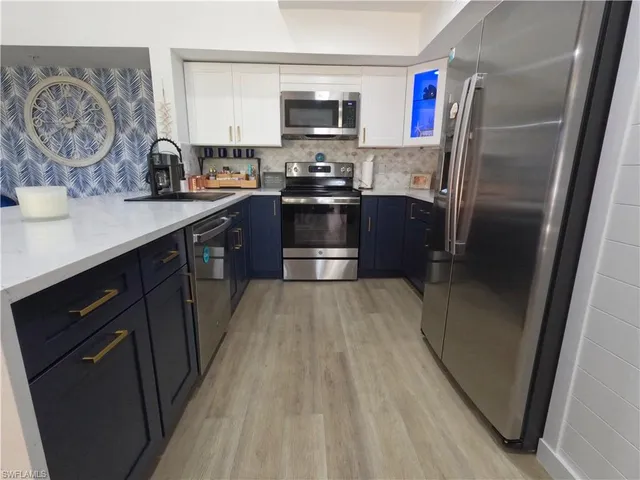 a view of kitchen with furniture and refrigerator