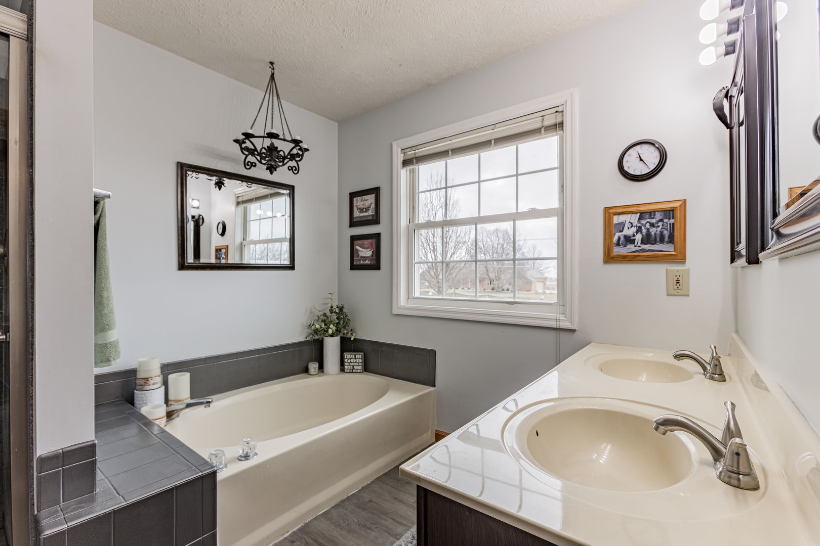 4401 Copper Ridge Road Champaign, IL 61822 - Photo 27 of 49 a bathroom with a tub a sink and a window