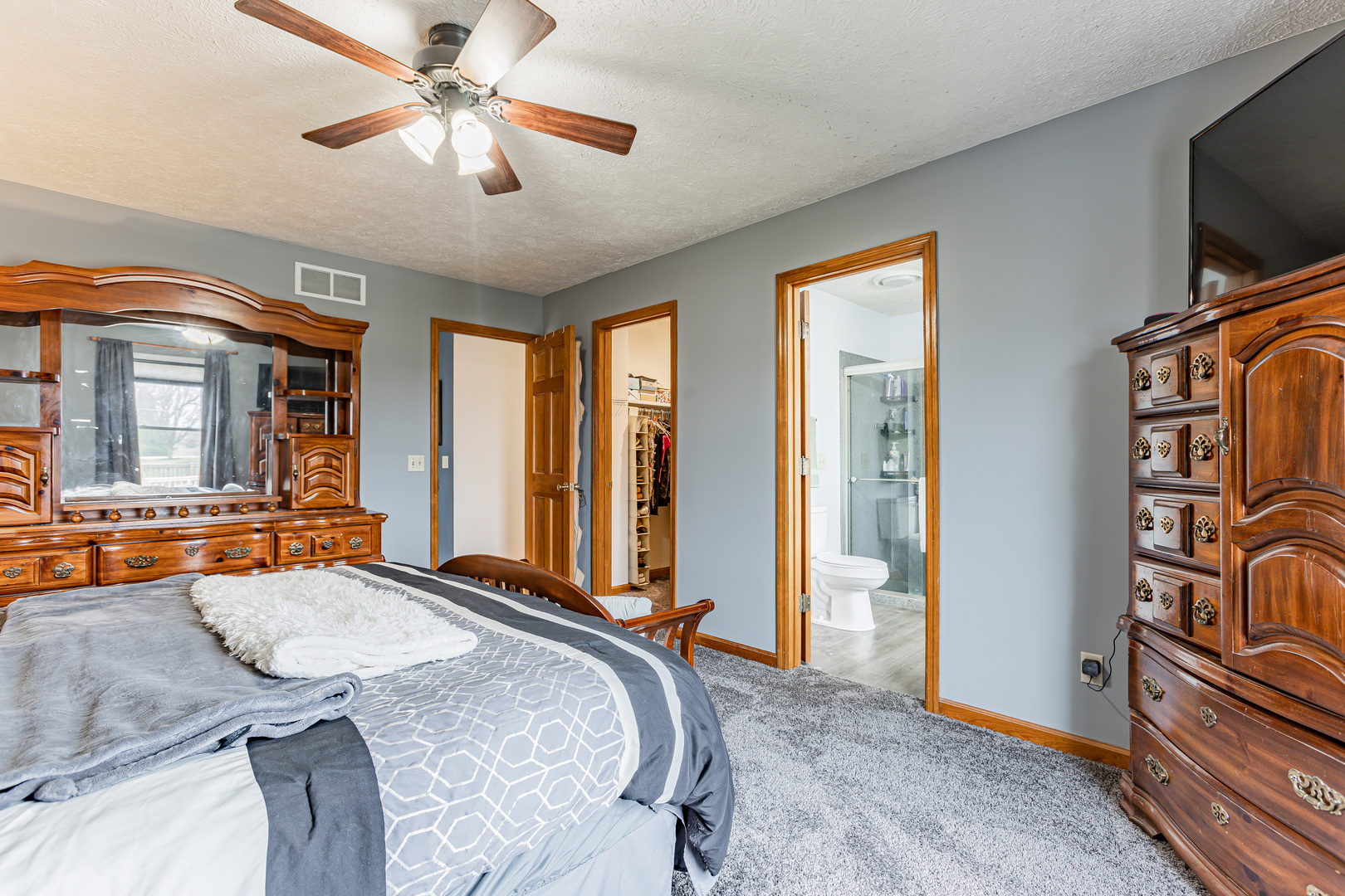4401 Copper Ridge Road Champaign, IL 61822 - Photo 30 of 49 a bedroom with a bed and ceiling fan